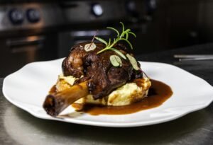 Delicious roasted lamb shanks served on creamy mashed potatoes with rich gravy.